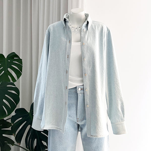 Studio Nicholson washed denim overshirt with a white t-shirt and a glass bead necklace