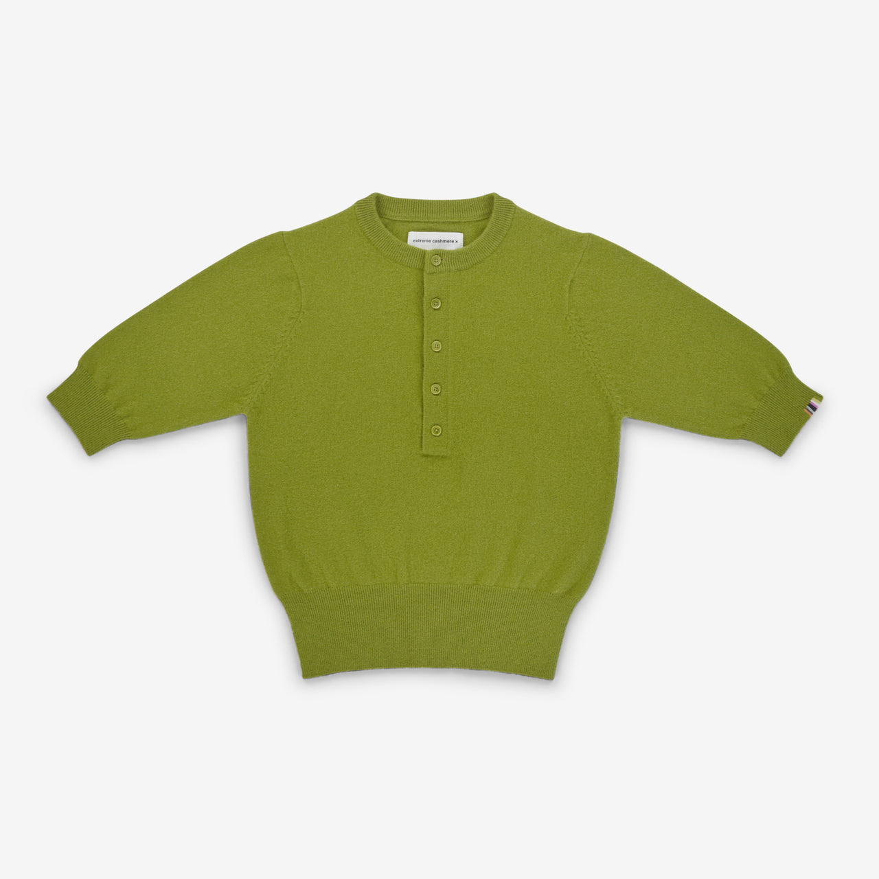 Green sweater with button details on a white background