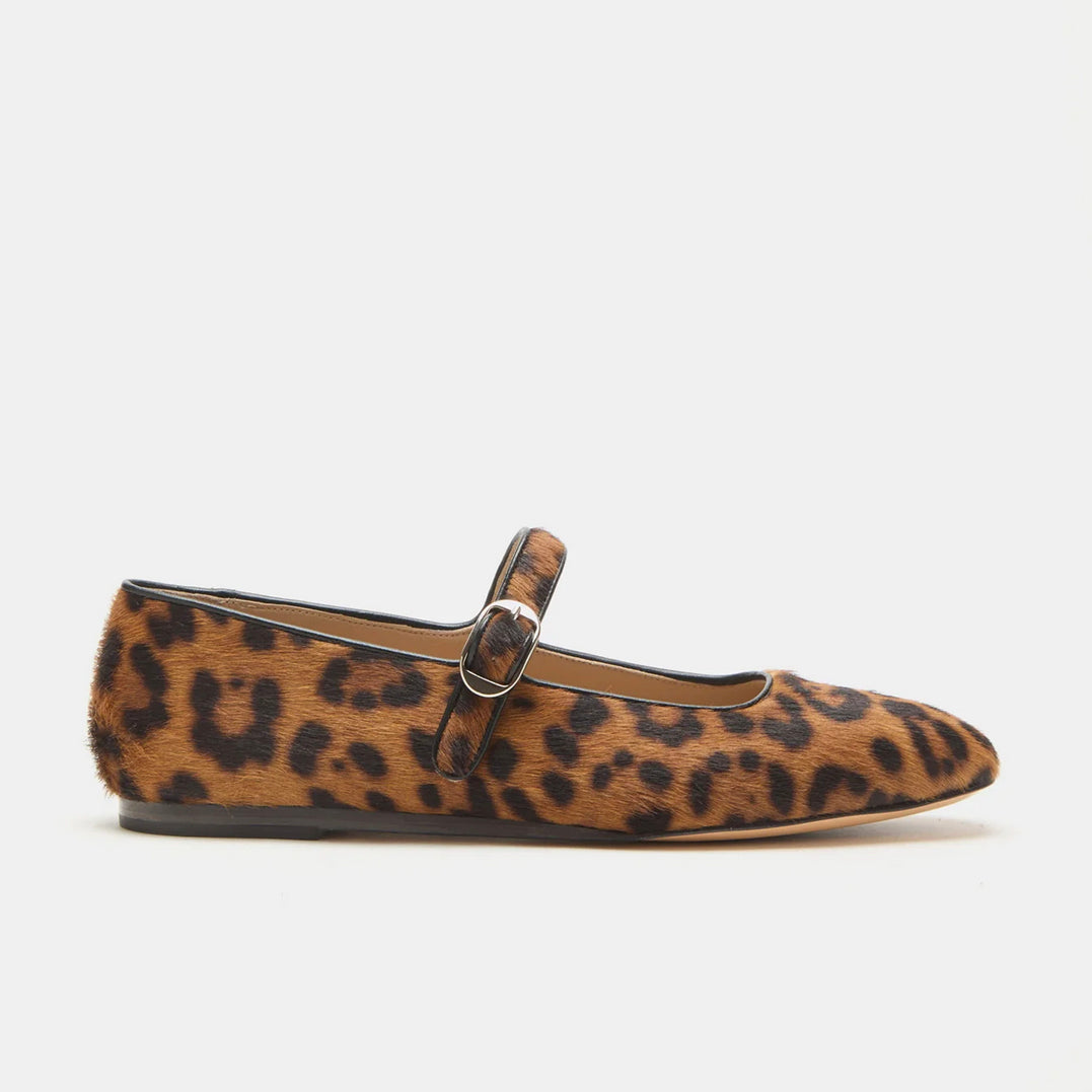 Leopard print flat shoe with a strap on a white background